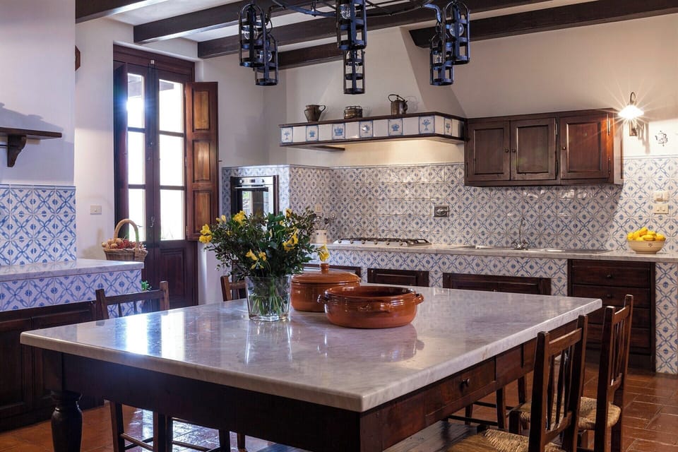 The kitchen serves both the indoor and the outdoor dining areas directly.