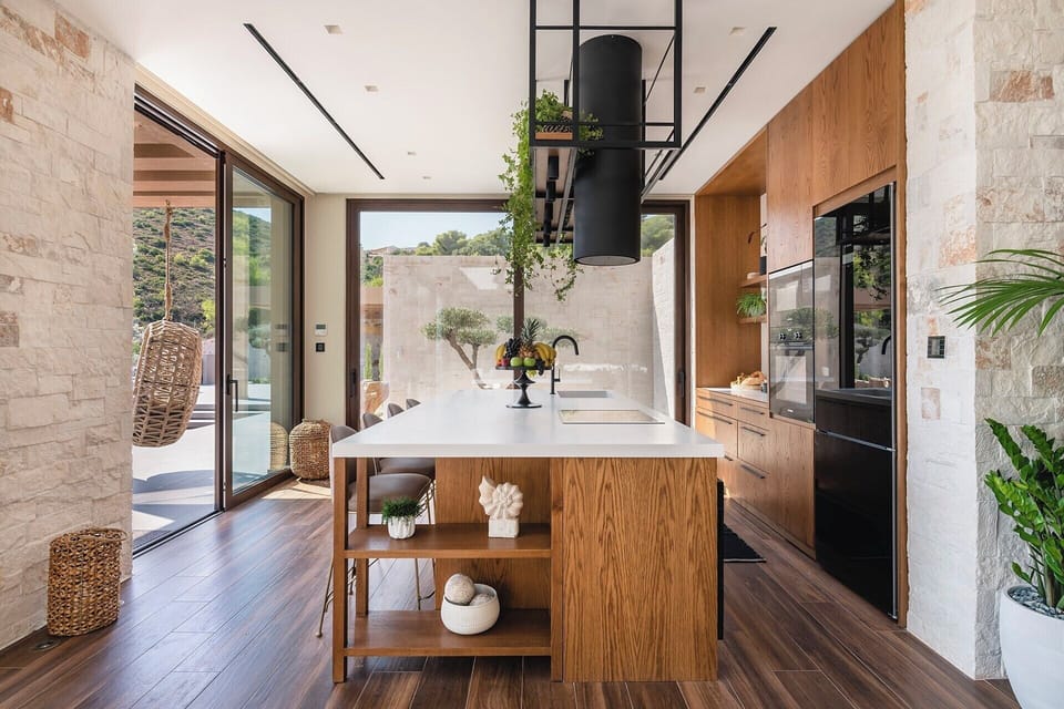 Banks of sliding glass windows allow the interiors to flow seamlessly outside.
