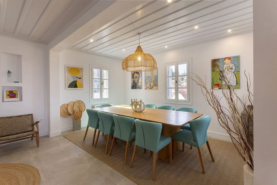The luminous, elegant dining area is part of a large open-concept social space.
