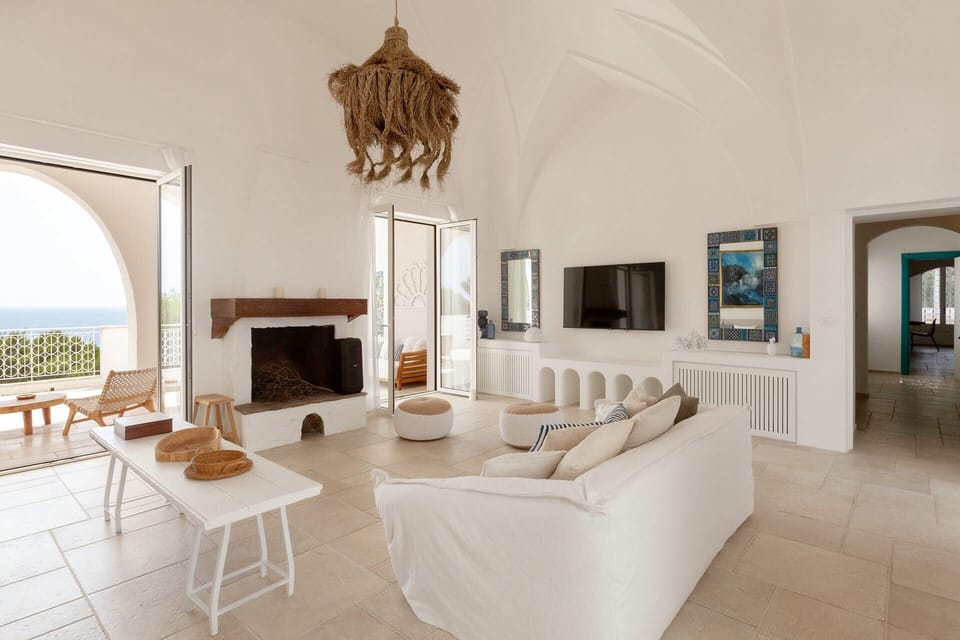 Blu Melia's bright, elegant living area, with its sea views and terrace access.