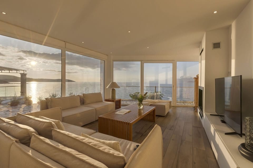 Walls of windows and glass doors make the very most of the unforgettable sea views.