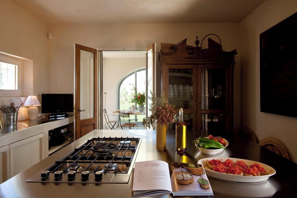 The modern kitchen with the dining room in the background.