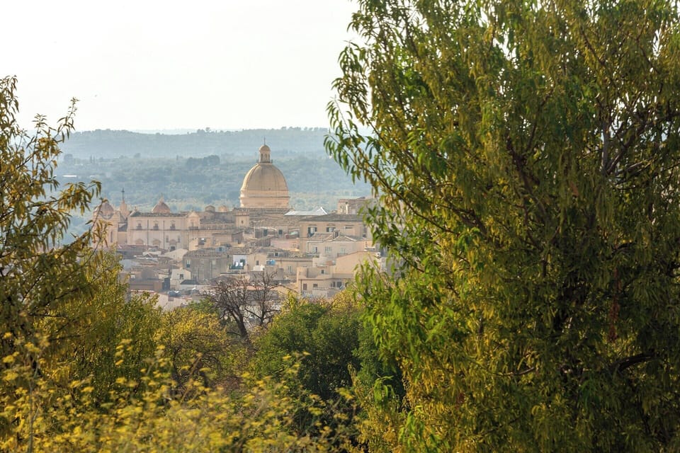The magnificent dome of Noto's cathedral seen from near the pool.