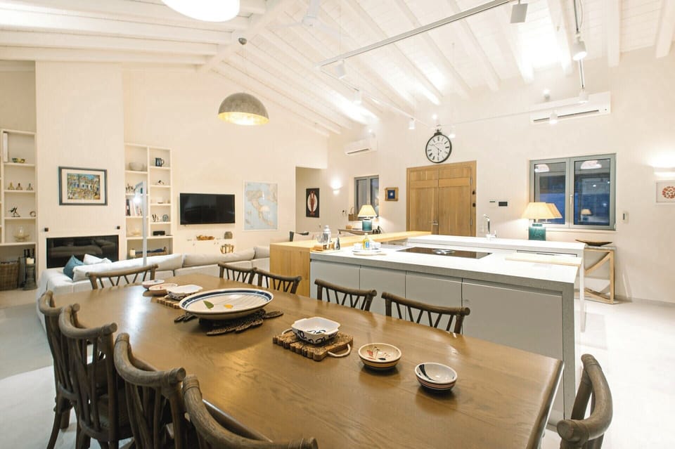 The kitchen and dining area with the living area behind.