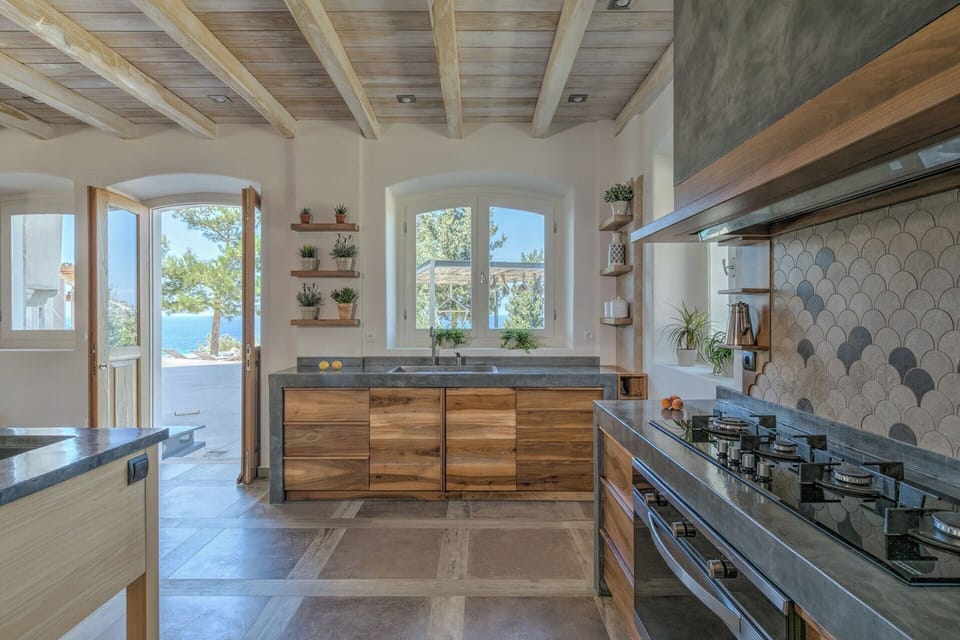 The kitchen offers sea views and opens out onto the terraces.