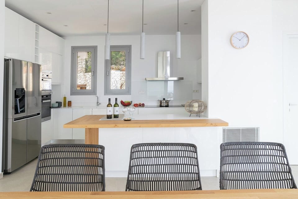 The fully-equipped contemporary kitchen seen from the indoor dining area.