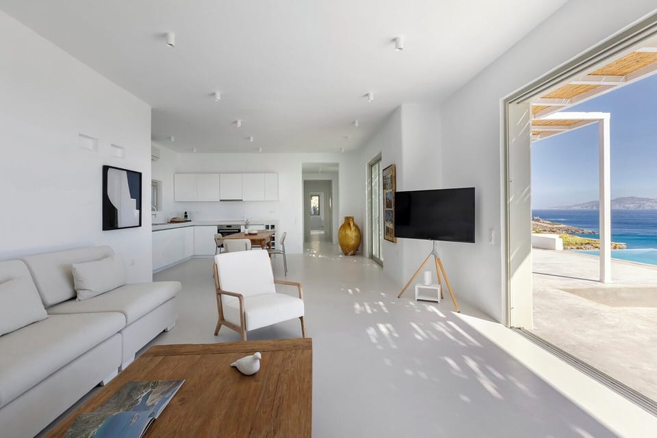 The clean lines and luminous atmosphere of the open-concept living and dining area and kitchen.