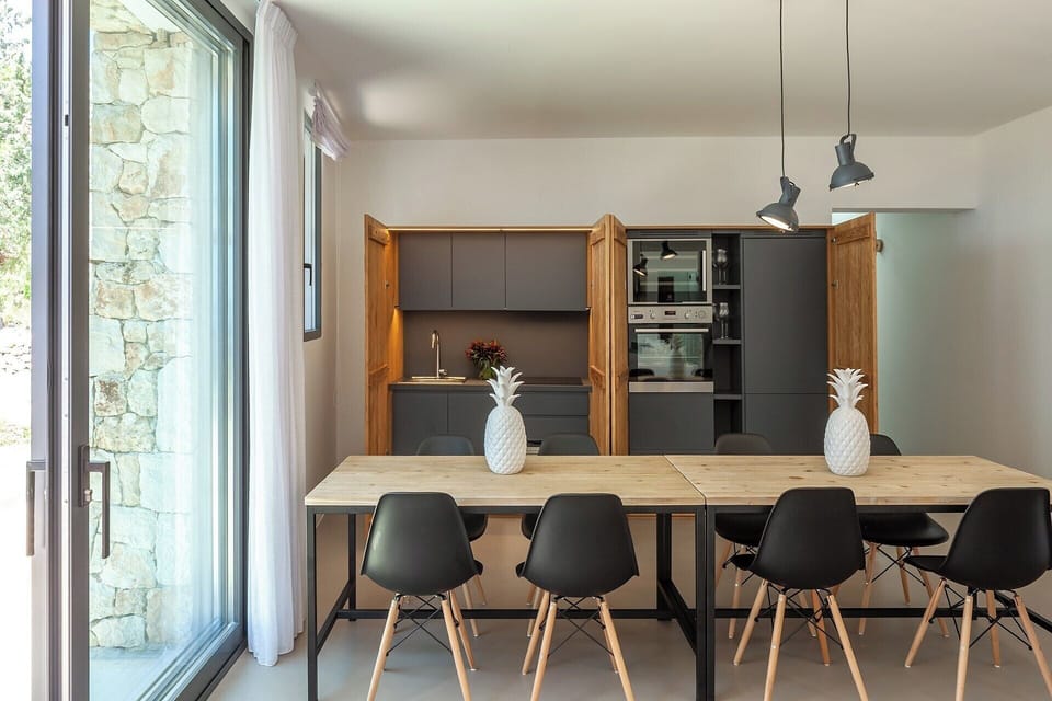 Cupboards open to reveal a kitchenette. 