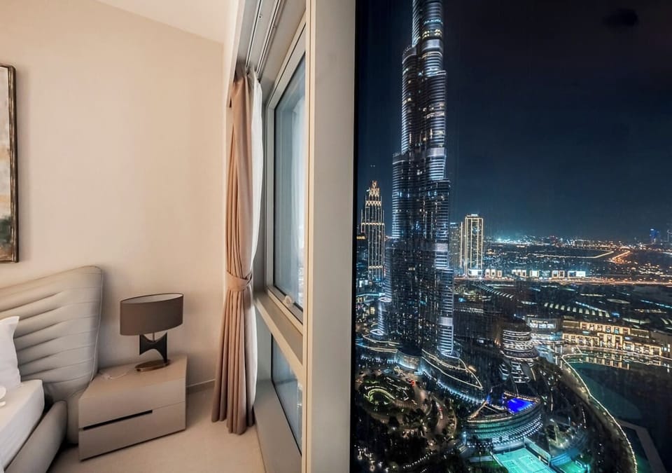 Luxurious Bedroom with Dazzling Burj Khalifa Night View.