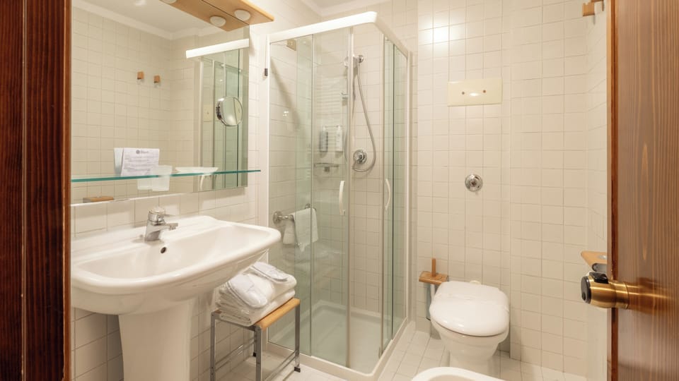 Shower, hair dryer, slippers, towels