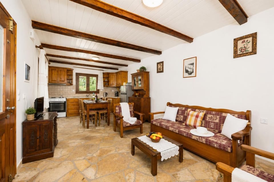 Open-plan living room with sofa, dining area, kitchen, WiFi internet, and satellite TV