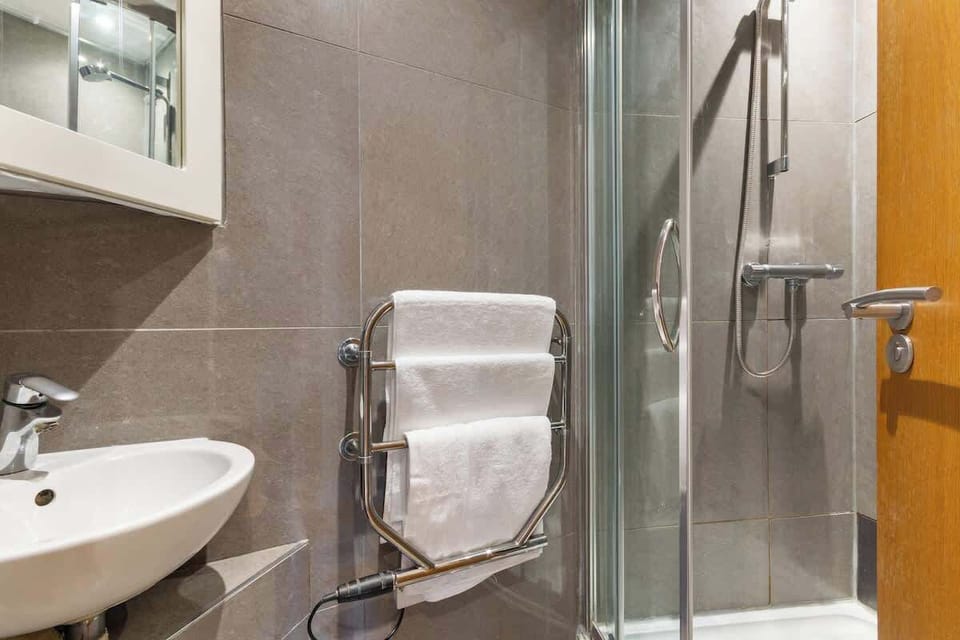 Spacious walk in Shower, heated towel racks, full bathroom.