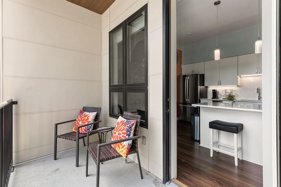 Private balcony with seating for two, that overlooks the pool