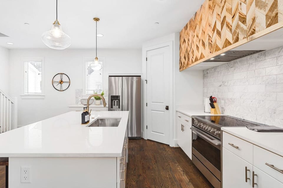High-end appliances, large pantry, and all the cooking supplies you might need in this bright & fresh kitchen with seating for four at the island.
