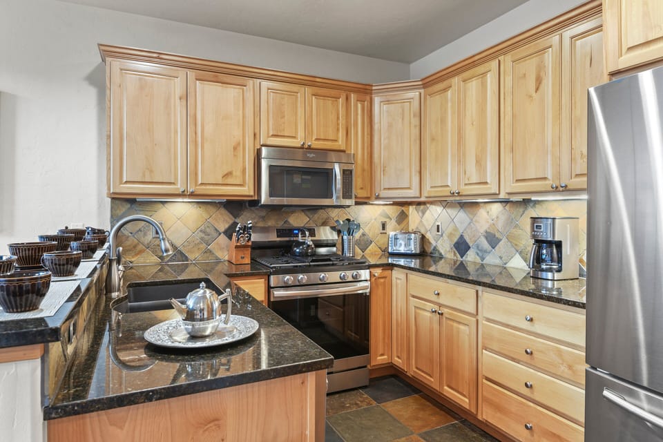 Dark Marbled Granite Shines Against The Beautiful Wood Cabinetry