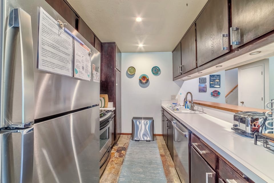 Full kitchen with stainless steel appliances.