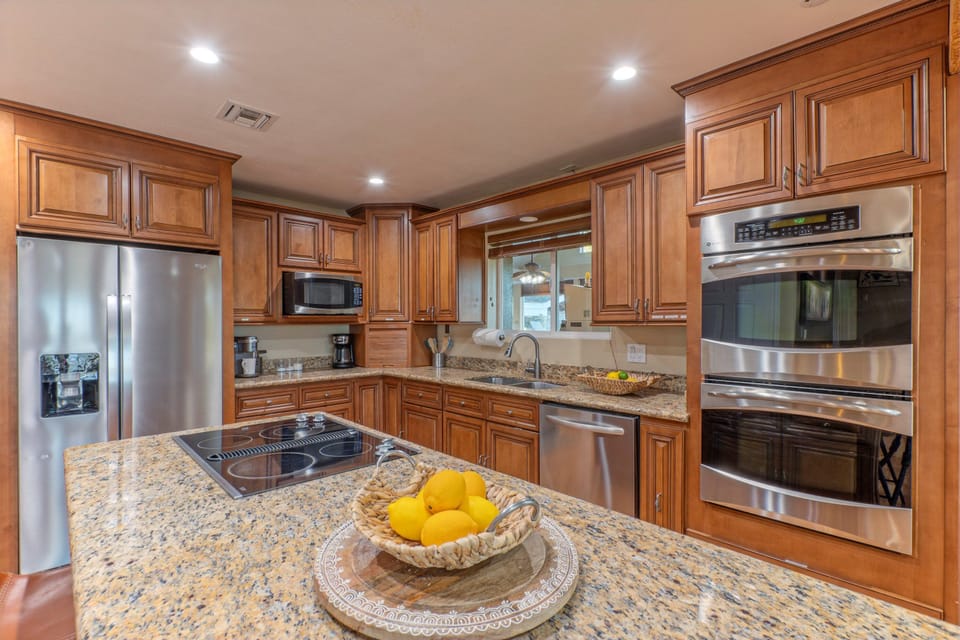 The kitchen is modern and has space for prepping and serving feasts.