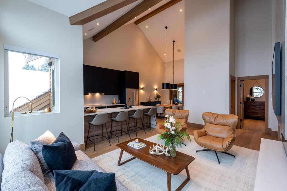 Living, kitchen and dining room is spacious, warm and inviting. Powder room and master bedroom to the right.