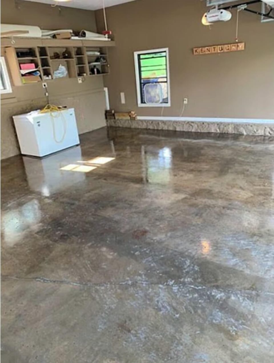Two-car garage with epoxy floor.