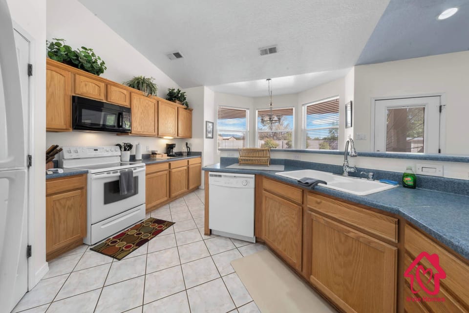 Charming kitchen with wooden cabinets and blue countertops.
