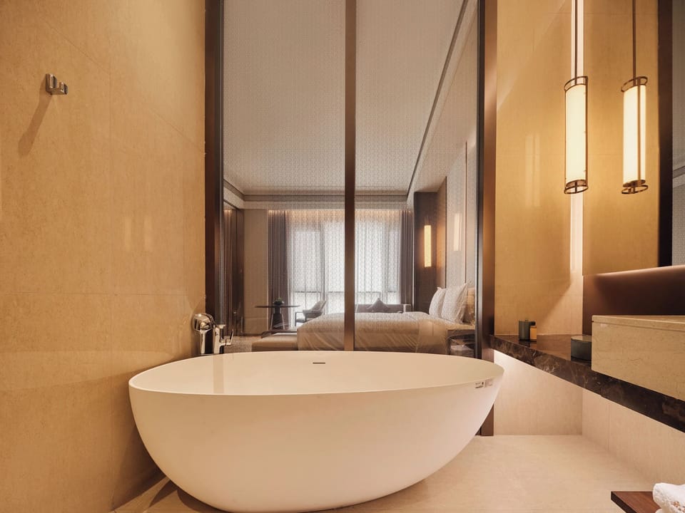 Executive Suite King Bed Room | Bathroom | Designer toiletries, hair dryer, bathrobes, towels