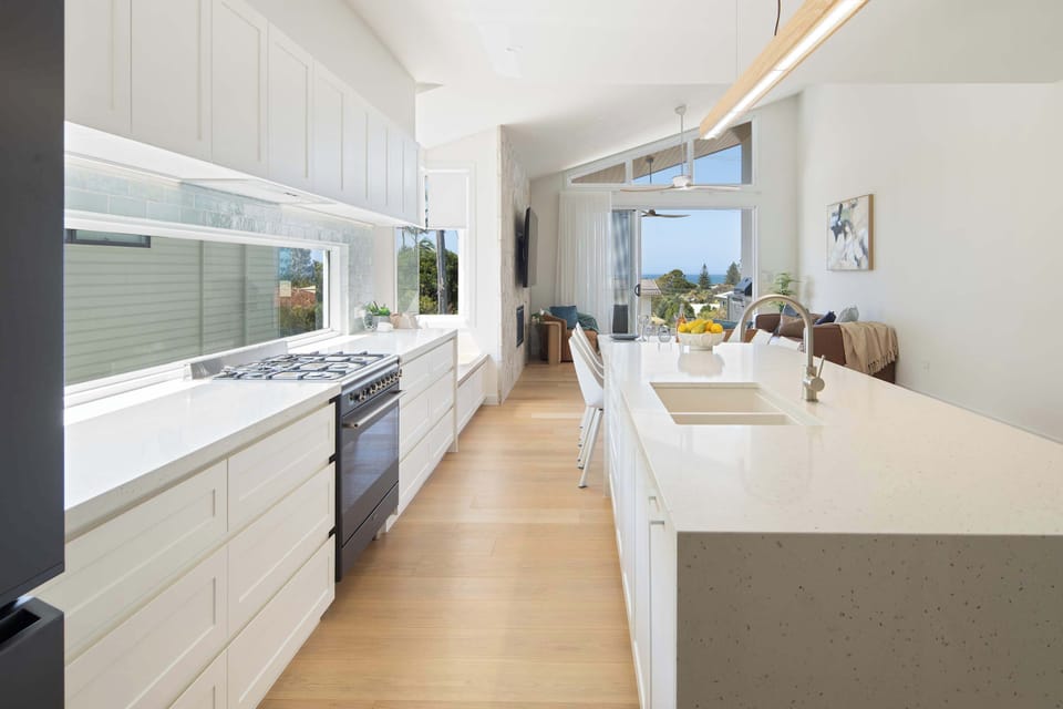 Sleek kitchen with long countertops, gas stove, and plenty of storage.