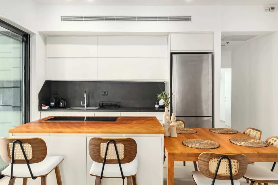 Spacious kitchen and dining area invites shared meals, with easy flow to nearby balcony views.
