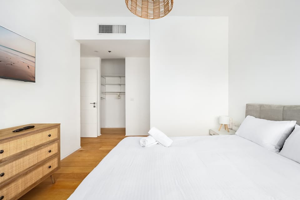 Calm bedroom layout with built-in storage creates a restful retreat after exploring nearby attractions.