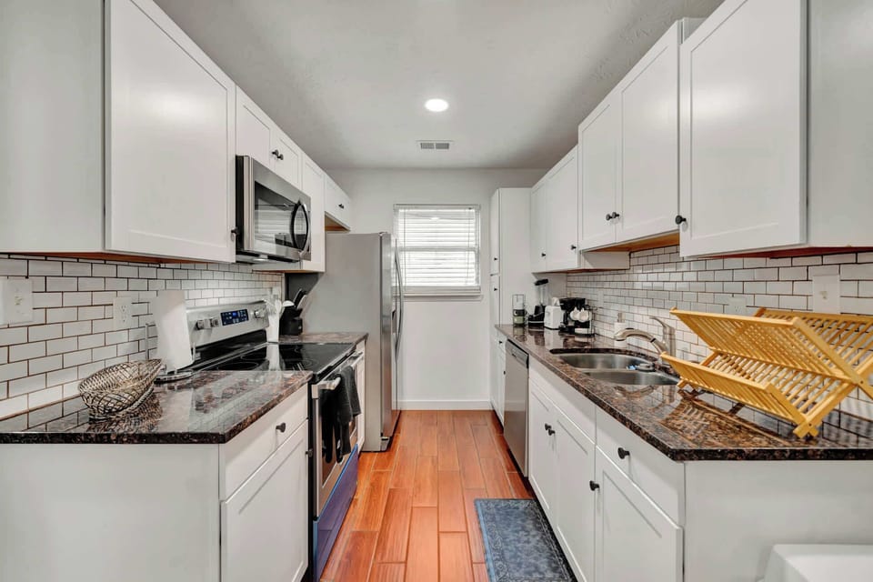 Our sleek kitchen fully equipped with modern appliances for your culinary needs!