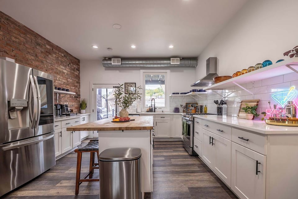 Bright, open, and fully stocked—this kitchen has everything you need to cook, sip, and gather. Whether you're prepping a meal or pouring a cocktail under the neon glow, it’s the heart of the home at Pitt Vibes.