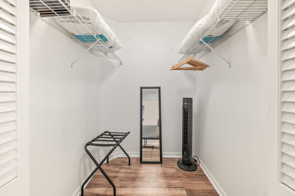 walk-in closet with hangers and extra storage.