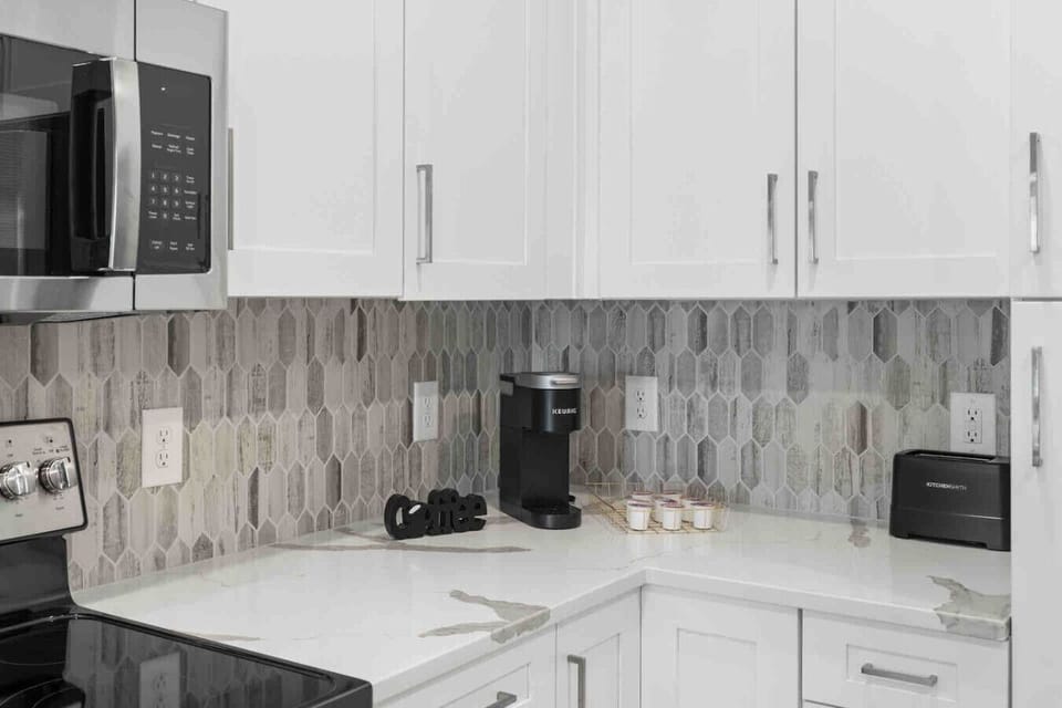 Coffee Station-Convenient coffee setup with Keurig machine, mugs, and pods ready to enjoy. A perfect spot to start your morning or unwind with a warm cup during your stay.