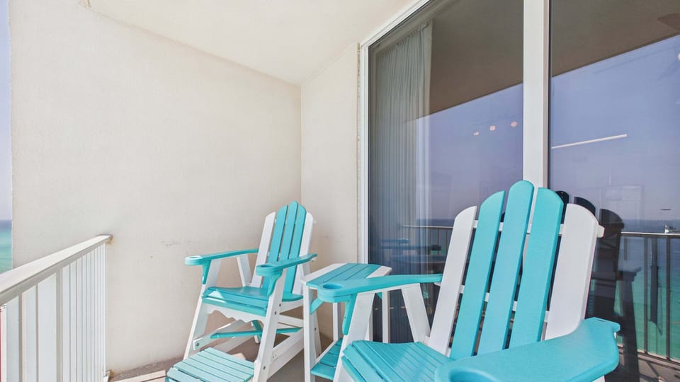 Spacious balcony with Adirondack high chairs and additional seating making for picture worthy views of the gulf