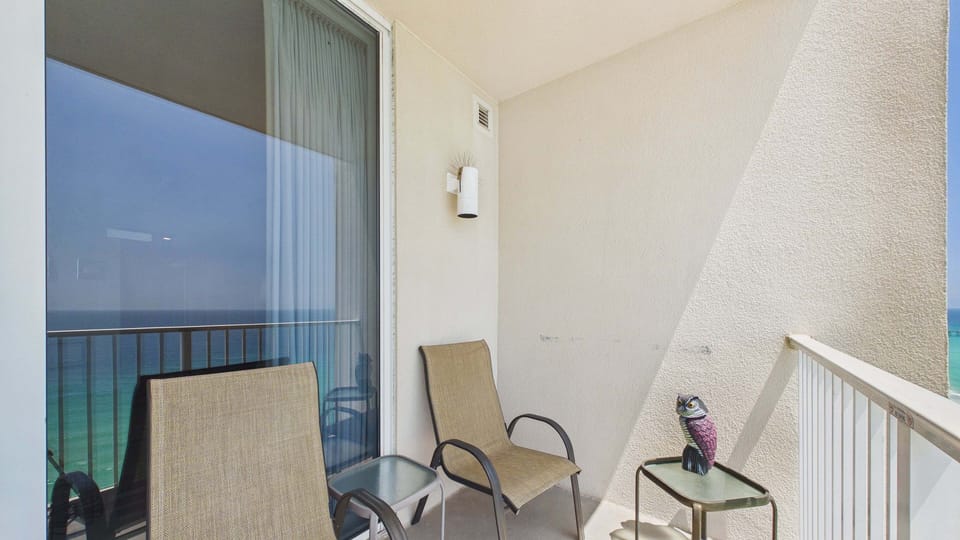 Spacious balcony with Adirondack high chairs and additional seating making for picture worthy views of the gulf