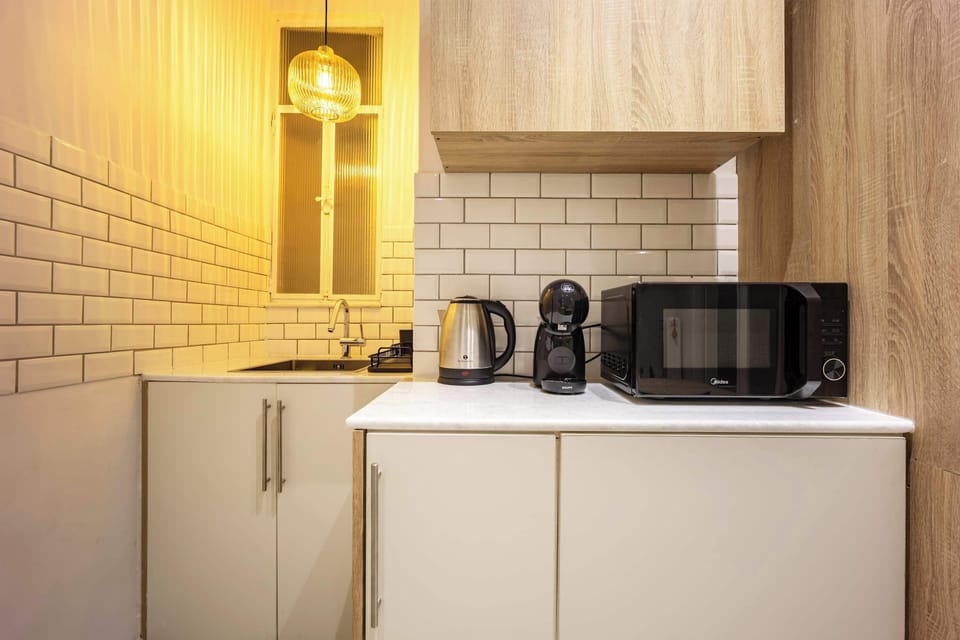 Compact, efficient kitchen setup with essentials ready, making morning coffees and simple meals effortless for guests.