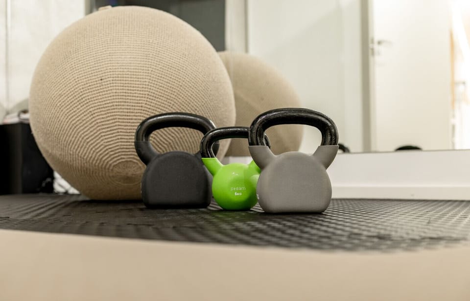 Quality equipment for your fitness routine, including kettlebells and a medicine ball.