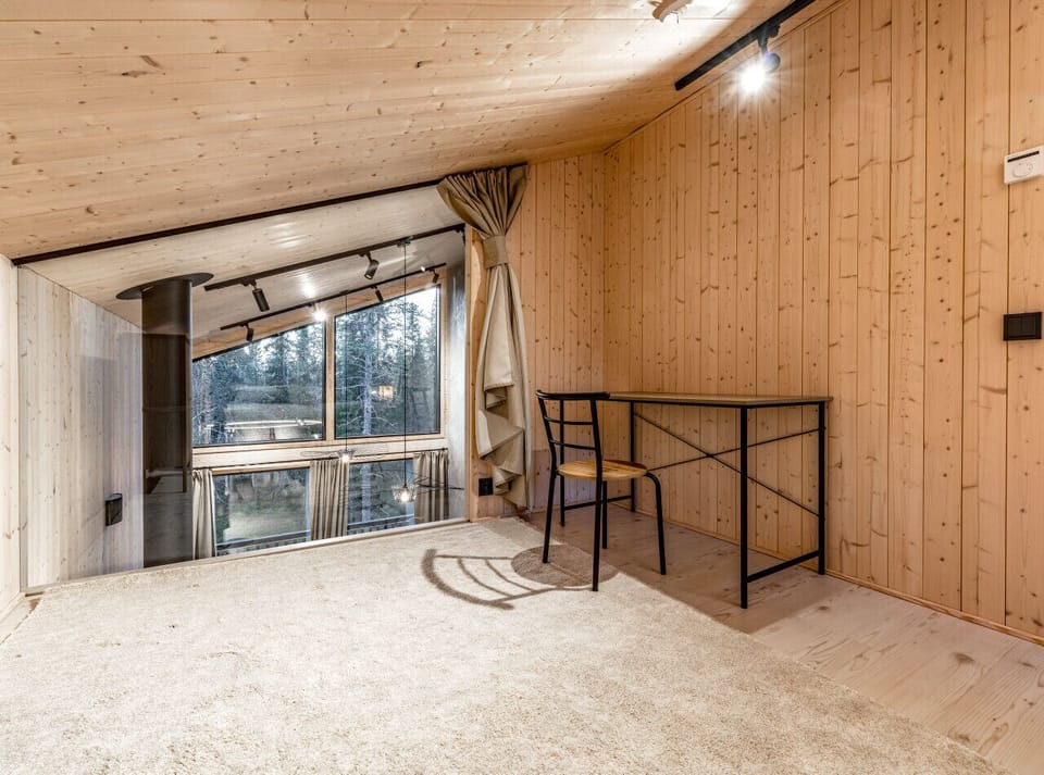 A versatile mezzanine area overlooking the living room, perfect for remote work or a quiet moment with a book.