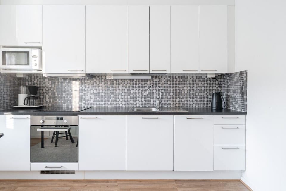 Modern, fully equipped kitchen with sleek white cabinetry and plenty of counter space.