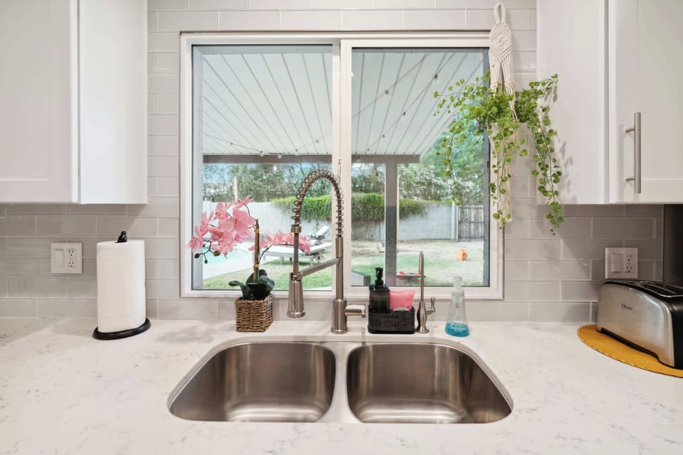Enjoy the sleek, modern appeal of the stainless steel sink, combining style with functionality for your convenience.