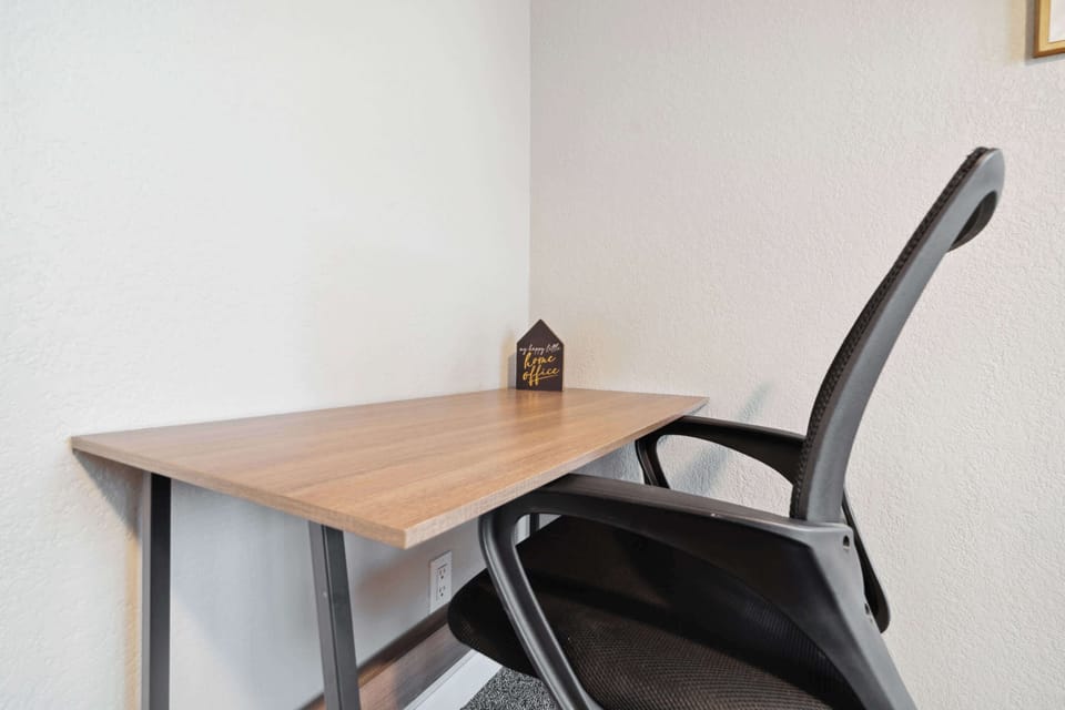 A spacious, well-lit workspace with a sturdy table, perfect for remote work.
