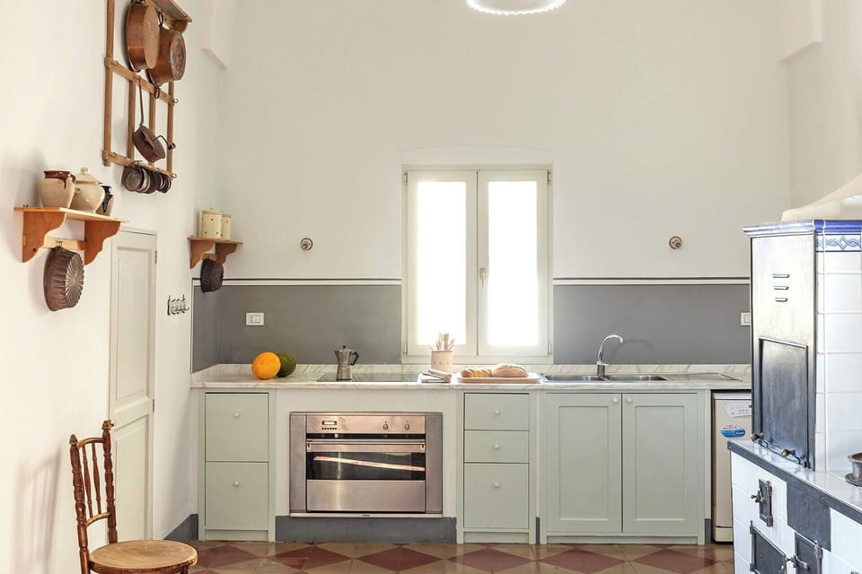 The kitchen mixes antique and super modern.