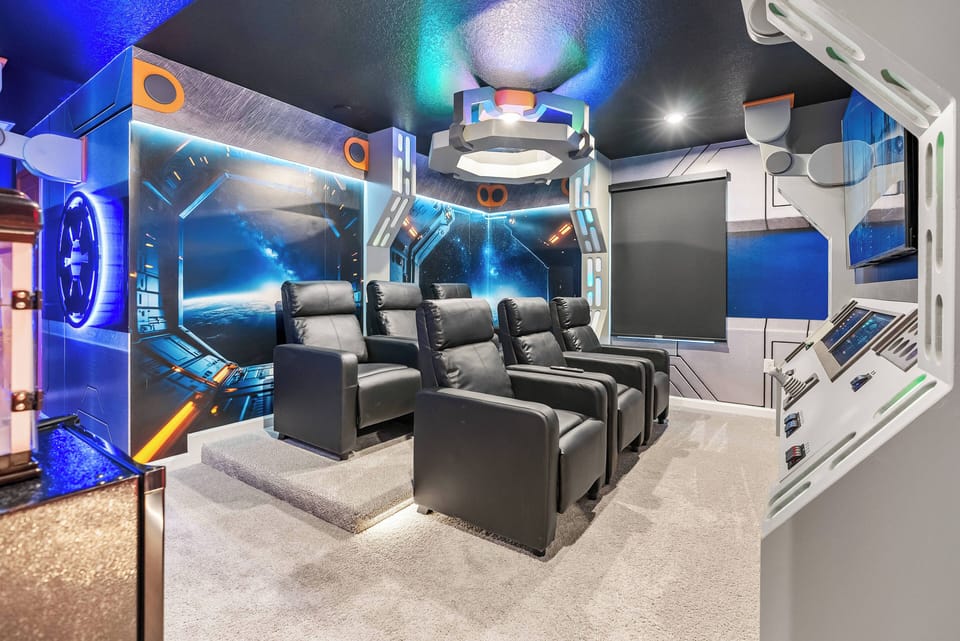 Enjoy a private cinema experience with luxurious leather recliners and modern decor that transport you. The vibrant, space-themed art and ambient lighting create an unforgettable atmosphere for every movie night.