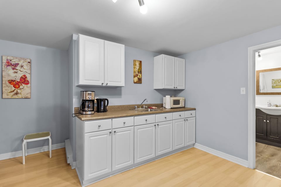 Sleek white cabinets and ample counter space. Includes a coffee maker and microwave to start your mornings right.
