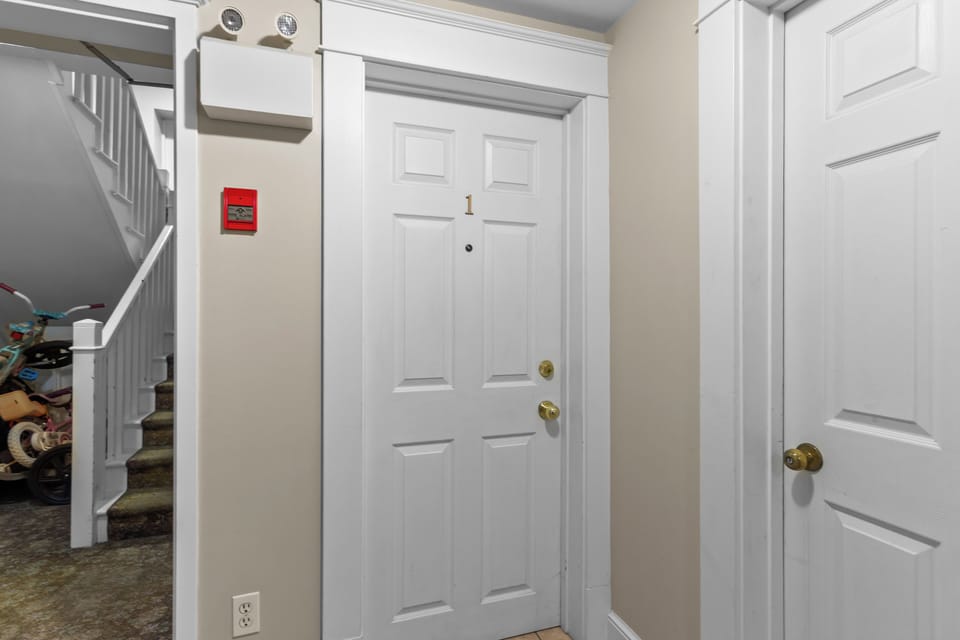 Secure private entrance to your unit. The building features clear numbering and a safety-first environment with integrated fire alarms.