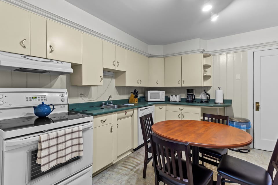 Functional kitchen space with plenty of cabinet storage. Well-stocked with a microwave, coffee maker, and essential cookware. Perfect for long-term stays or quick morning breakfasts.