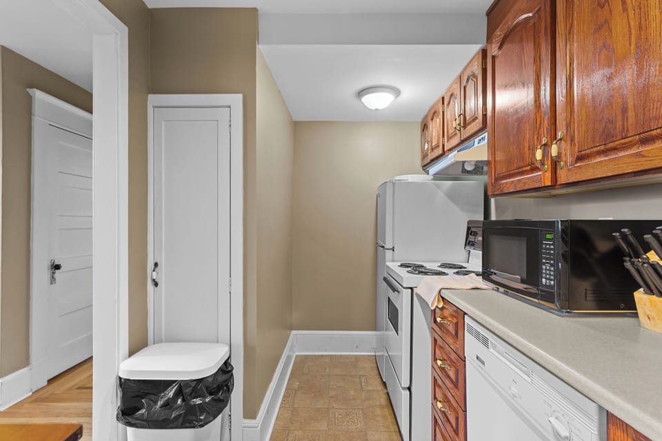 Galley Kitchen Efficiency.  A bright and functional kitchen layout with ample storage and modern appliances, making meal prep easy during your vacation.