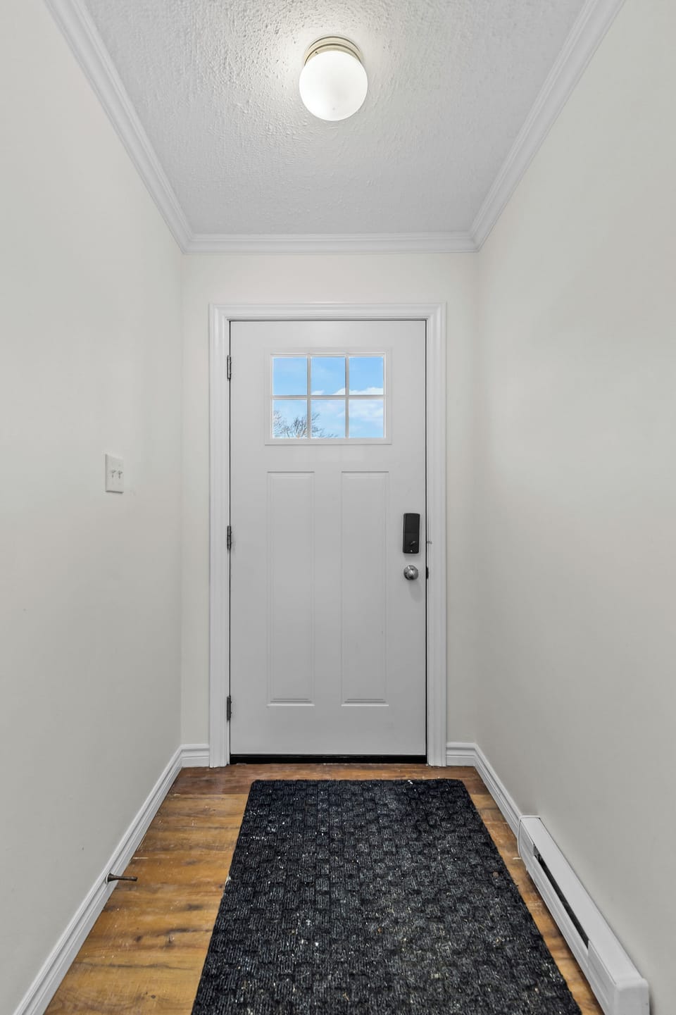 Entryway: Secure and private entrance featuring a smart lock for easy self-check-in. Clean, minimalist design welcomes you home.