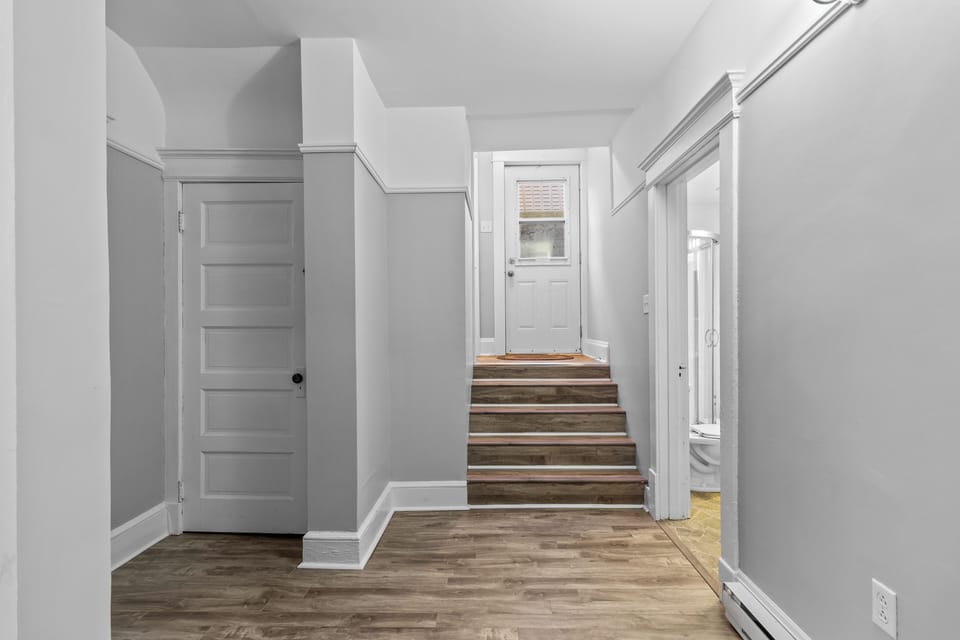 Entryway: Spacious entryway with a mudroom area for coats and shoes, leading up to the main living quarters.