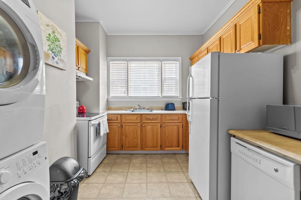 Fully equipped kitchen with classic wood cabinetry, full-sized stove, and refrigerator. Everything you need to prepare home-cooked meals during your stay.