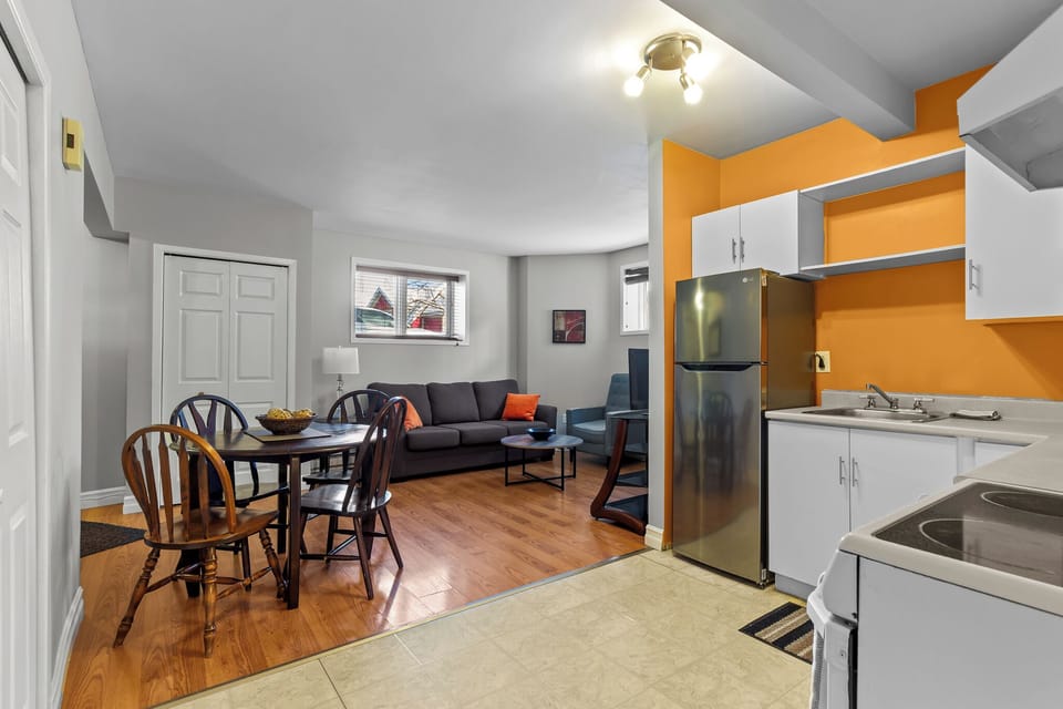 A wide view showing the seamless flow between the dining area, living room, and kitchen—ideal for socializing and entertaining guests.
